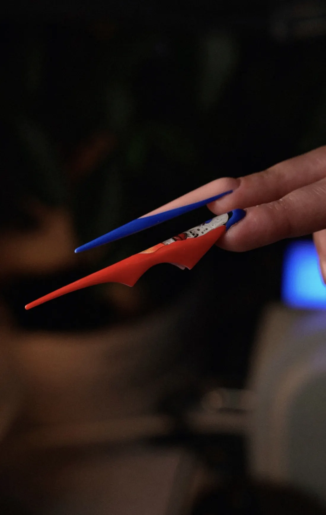 Side profile of blue and red student nail work